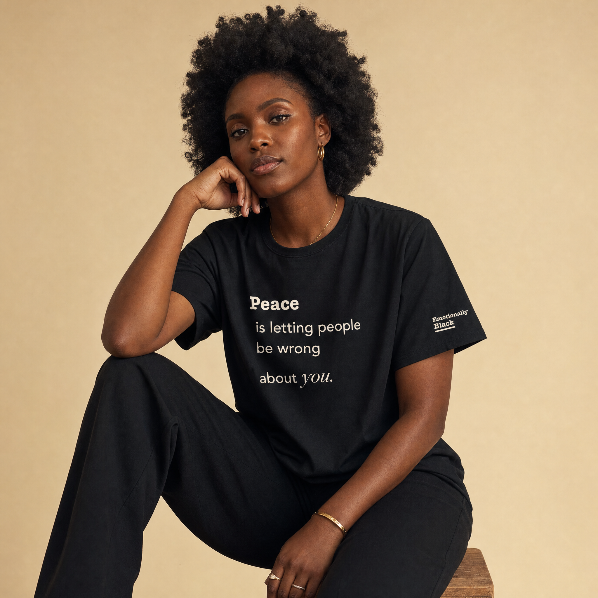 Black woman in the Blackety Black Peace ladies slim-fit tee — cream-ink statement print