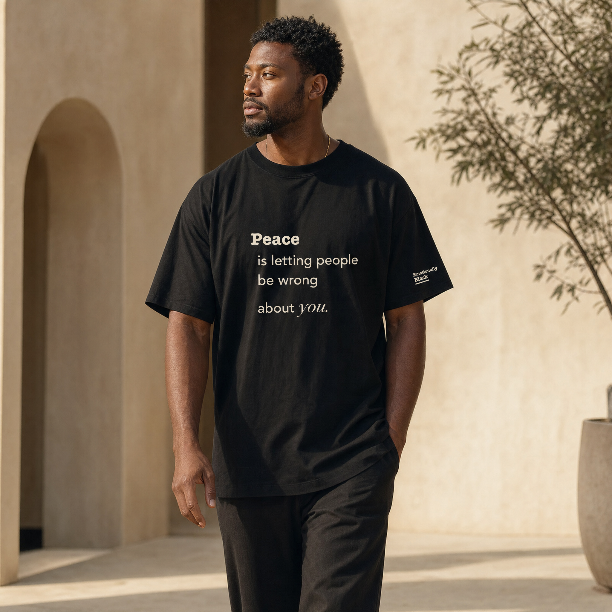 Black model in the Blackety Black Peace Is Letting People Be Wrong About You tee — cream-ink statement print