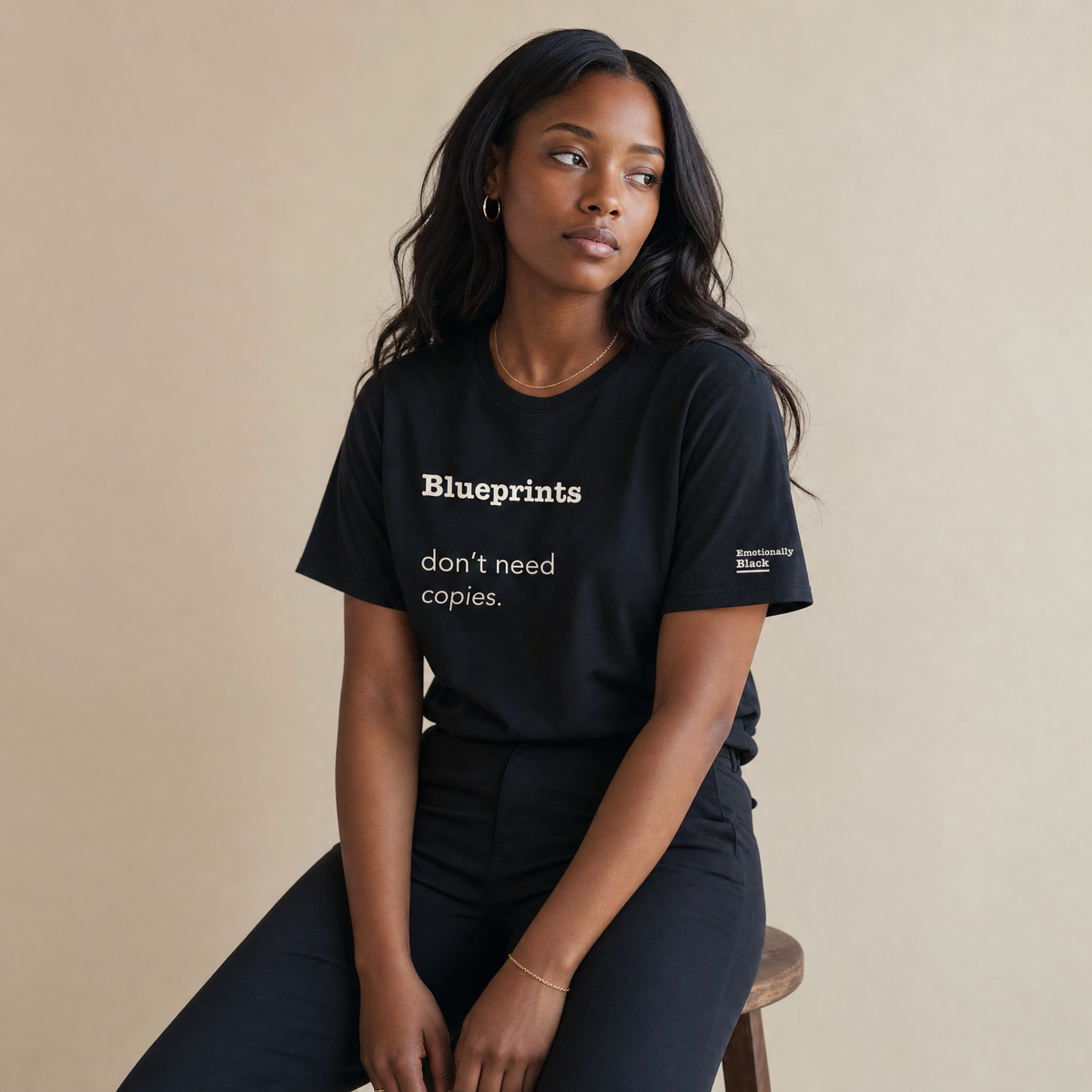 Black woman in the Blackety Black Blueprints Don't Need Copies ladies slim-fit tee — cream-ink statement print