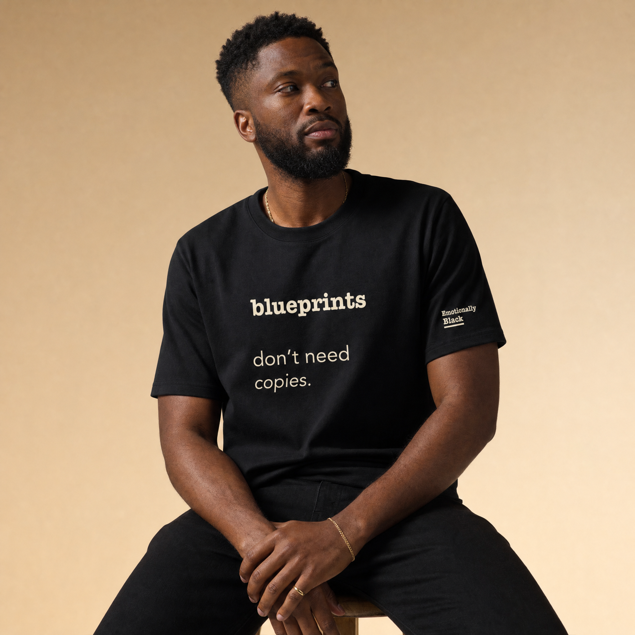 Black model in the Blackety Black Blueprints Don't Need Copies tee — cream-ink statement print