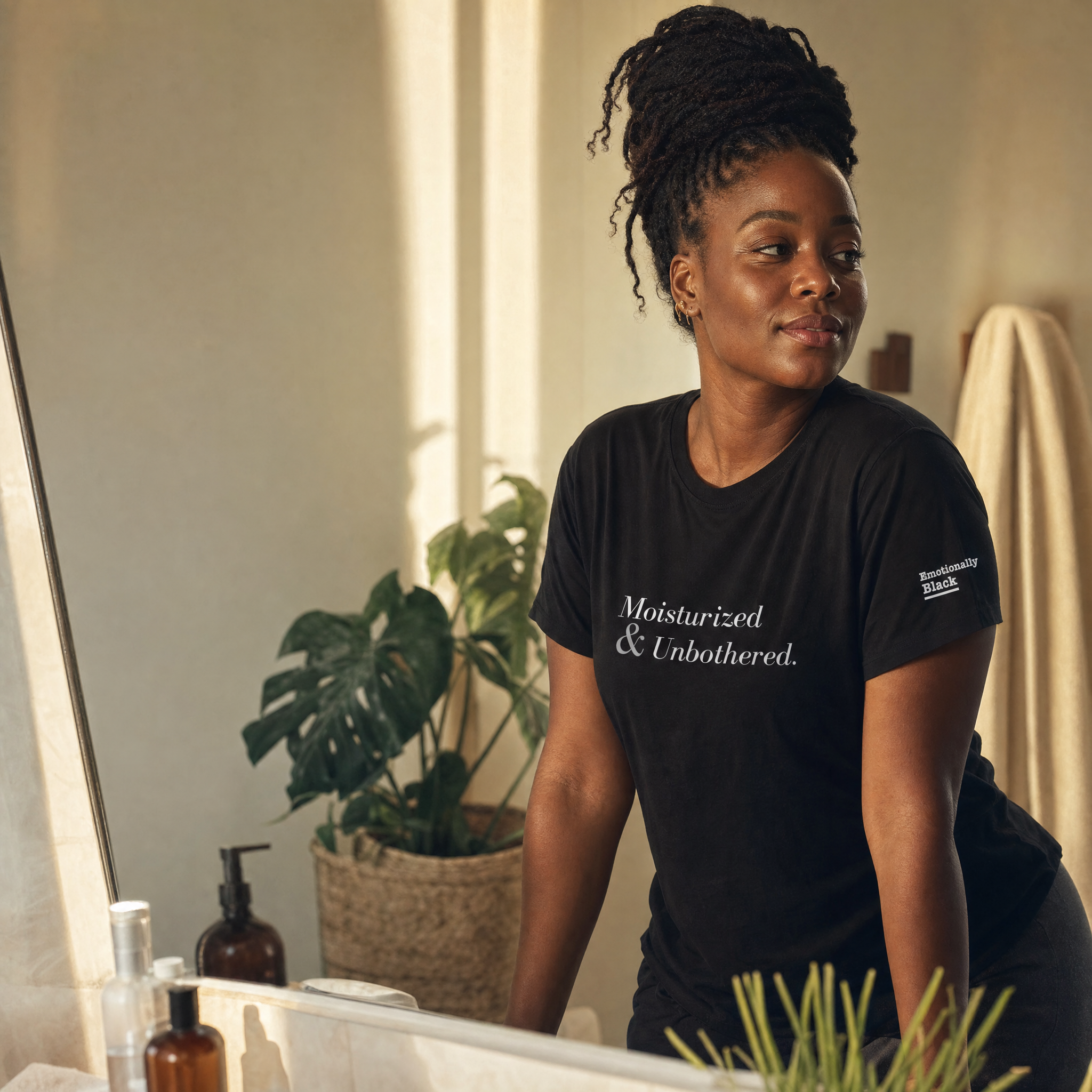 Black woman in the Blackety Black Moisturized and Unbothered ladies slim-fit tee — cream-ink statement print